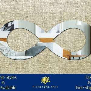 May include: A silver infinity mirror with a reflection of a bedroom interior. The mirror is on a beige textured background. Multiple Styles & Sizes Available. Fast & Free Shipping! Richstone Arts.