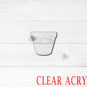May include: A clear acrylic plant pot cutout. The pot is shaped like a traditional flower pot with a rounded bottom and a straight top.