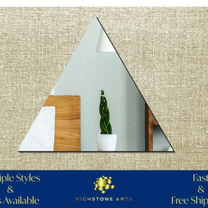 May include: A triangular mirror with a beveled edge, reflecting a room with a wooden headboard, white bedding, and a potted plant. The mirror is framed in a thin black border. The text "RICHSTONE ARTS" is visible below the mirror.