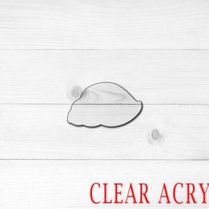 May include: A clear acrylic cookie cutter shaped like a half-moon or crescent.