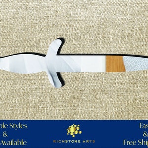 May include: A white, wooden, decorative dagger with a brown wood accent. The dagger is on a beige fabric background. Multiple Styles & Sizes Available. Fast & Free Shipping! Richstone Arts.