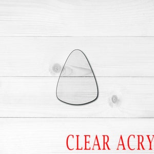 May include: A clear acrylic candy corn shape, perfect for crafting or decorating.