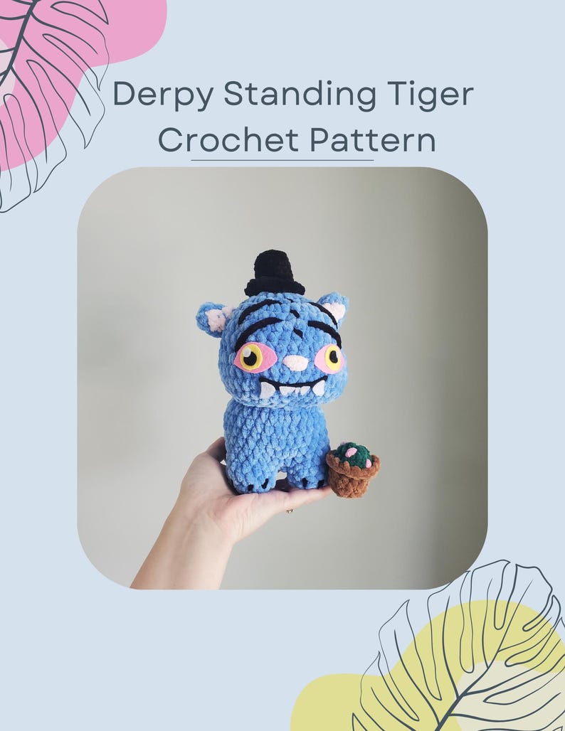 May include: A blue crochet tiger with a black top hat and a small brown pot with a green plant. The tiger has yellow eyes and a wide, toothy grin. The text "Derpy Standing Tiger Crochet Pattern" is at the top of the image.