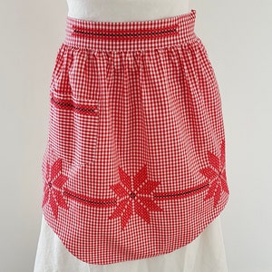 vintage circa 1950s Domestic Goddess Half Apron, Red and White Gingham with embroidery detail and one pocket. In excellent vintage condition. 
One Size. Width across the top 42cm plus ties, length through centre 52cm each fabric tie is 49cm long.