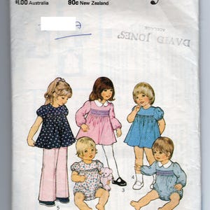 May include: A vintage "Style" sewing pattern for toddlers, size 2, with a 53 cm breast measurement. The cover shows illustrations of children's clothing, including dresses and rompers. The pattern is from Australia and New Zealand.