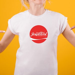 May include: White t-shirt with a red circle graphic that says "Enjoy Jesus Christ Thou Shalt Never Thirst".