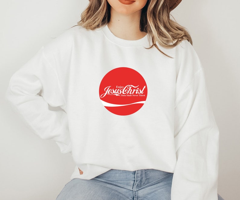 May include: White sweatshirt with a red circle logo that says "Enjoy Jesus Christ Thou Shalt Never Thirst".