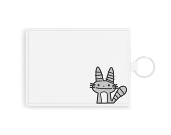 May include: White leather key chain with a grey cartoon cat design and a silver ring.