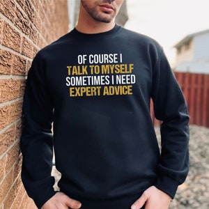 Puede incluir: Sudadera negra con el texto "Of course I talk to myself sometimes I need expert advice" en letras doradas.