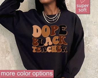 May include: Black sweatshirt with the text "Dope Black Teacher" in retro-style lettering with brown, black, and tan colors.