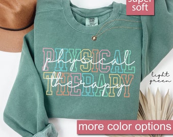 May include: Light green sweatshirt with the text "PHYSICAL THERAPY" in rainbow colours. The sweatshirt is super soft and has more colour options.