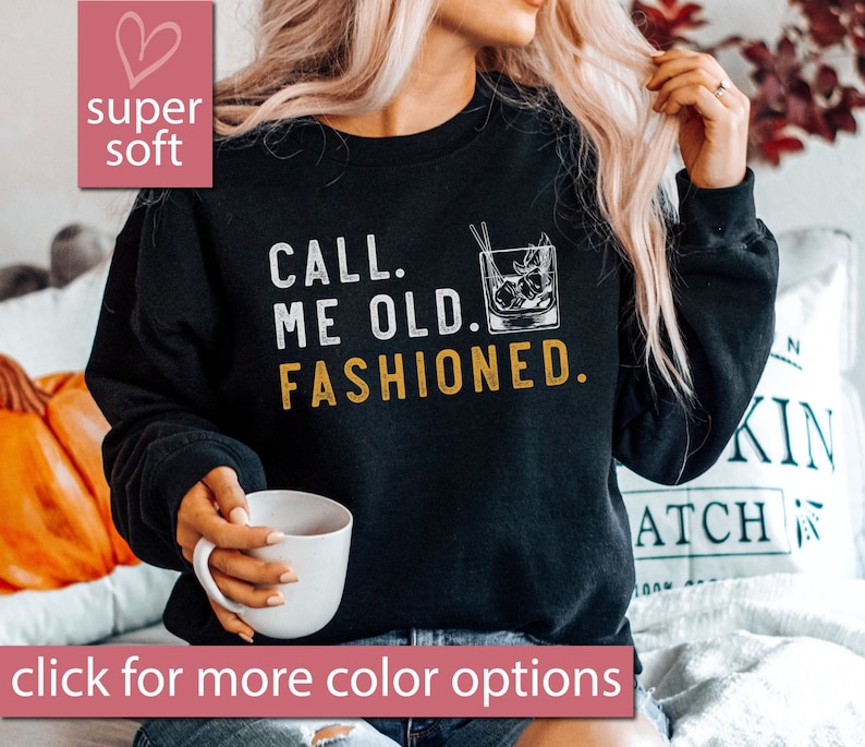 May include: Black sweatshirt with the text "CALL. ME OLD. FASHIONED." in white lettering and a drawing of an old fashioned cocktail glass in black and white.