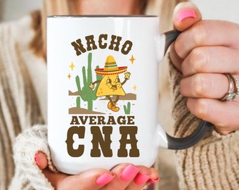 May include: White ceramic mug with a black handle. The mug has a cartoon image of a nacho wearing a sombrero and the text "Nacho Average CNA".