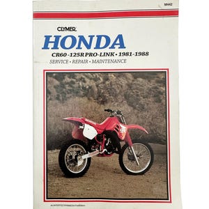May include: A Clymer Honda service manual for CR60-125R Pro-Link motorcycles, covering the years 1981-1988. The cover shows a red Honda motorcycle on a dirt track. The manual provides service, repair, and maintenance information.