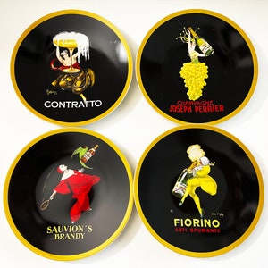 May include: Four black and gold coasters with different images and text. The coasters feature images of women in vintage-style clothing and text that reads "Contratto", "Champagne Joseph Perrier", "Sauvion's Brandy", and "Fiorino Asti Spumante".