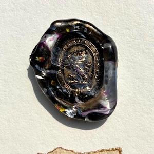 May include: A white ceramic mug with a black handle and the text "But First, Coffee" in a handwritten style. The mug is on a white surface. The mug is 10 cm tall.