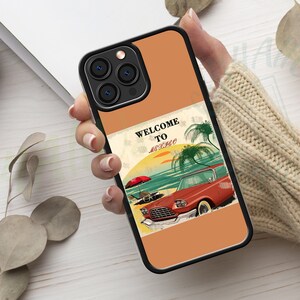 May include: A phone case with a retro-style illustration of a car driving on a beach with palm trees and the text "Welcome to Mexico". The case is orange with black accents.