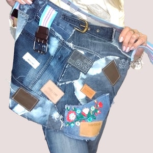 May include: A blue denim tote bag with a brown leather strap and various patches, including a floral embroidered patch with the word "MINISO" and a patch with the text "CROSS HATCH".