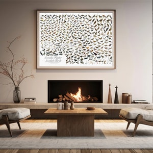 May include: A framed poster with a white background and a grid of colorful bird illustrations. The poster is titled "Scandinavian Flycatcher Scandinavian Birds". The poster is hanging on a white wall above a fireplace with a fire burning inside. There are two beige armchairs on either side of the fireplace.