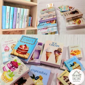 May include: A collection of miniature books with colorful covers featuring various desserts, including cakes, cupcakes, ice cream, milkshakes, and cookies. The books are arranged on a shelf and a table, creating a charming and whimsical display.
