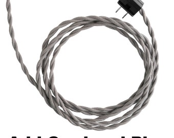 May include: A close-up of a gray fabric-covered electrical cord with a black plug. The cord is coiled in a circle. The text "Add Cord and Plug" is visible below the cord.