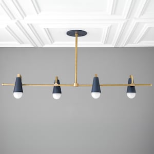 May include: A gold and navy blue four-light chandelier with a long, straight bar and cone-shaped shades.