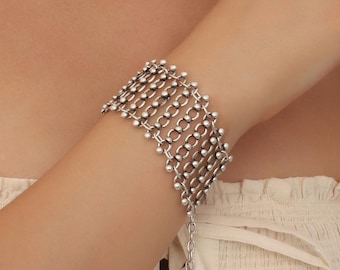 May include: A silver bracelet with a chain link design and small round beads. The bracelet is adjustable with a chain extension.