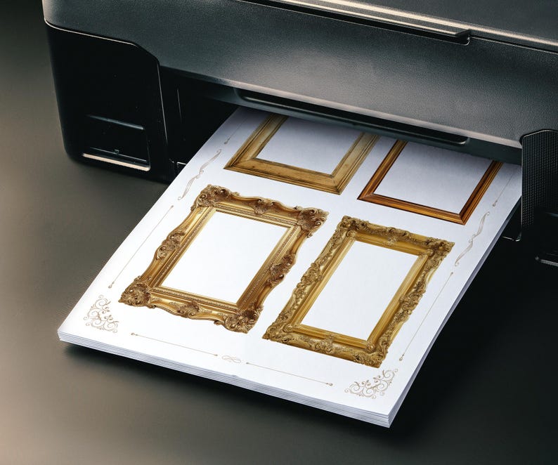 May include: A black printer producing a sheet of paper featuring four decorative gold picture frame designs. The frames, with detailed ornamentation, are set against a white backdrop. The paper is emerging from the printer.