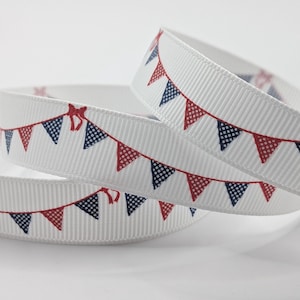 May include: White ribbon featuring a repeating pattern of red and navy blue bunting flags. The flags are connected by a red line and are printed on a white ribbed ribbon. The ribbon is rolled into a spiral.