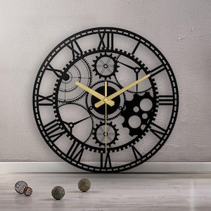 Könnte beinhalten: Schwarze Wanduhr aus Metall mit römischen Ziffern und einem Zahnrad-Design. Die Uhr hat goldfarbene Zeiger.