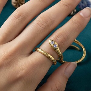 May include: A set of three ceramic mugs with a speckled, matte finish. The mugs are in shades of cream, light gray, and dark gray. Each mug has a simple, minimalist design, perfect for coffee or tea.