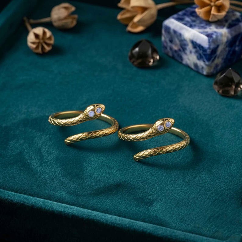 May include: A white ceramic mug with a black handle and the text "But First, Coffee" in a handwritten style. The mug is on a white surface. The mug is likely for hot beverages.