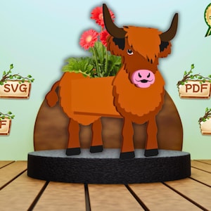 May include: A brown and orange Highland cow planter with red flowers. The cow-shaped planter has a rectangular body for plants and sits on a black base. Digital download options are shown.