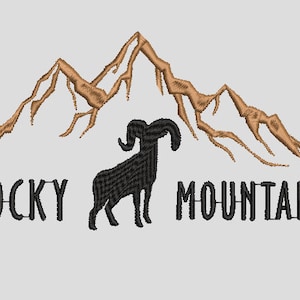 May include: Embroidered design featuring the words "Rocky Mountains" in black, with a black ram silhouette and brown mountain range above. The design is on a light gray background.