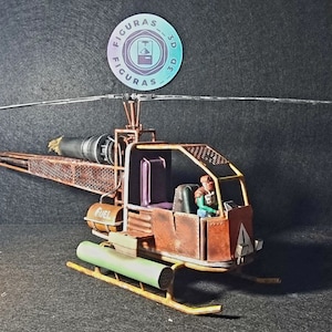May include: A rusty brown, model helicopter with a green and brown fuel tank, a yellow frame, and two figures in the cockpit. The helicopter has a long, thin, silver propeller.