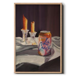 May include: A still life painting of a can of La Croix sparkling water on a white tablecloth with two lit candles in the background.