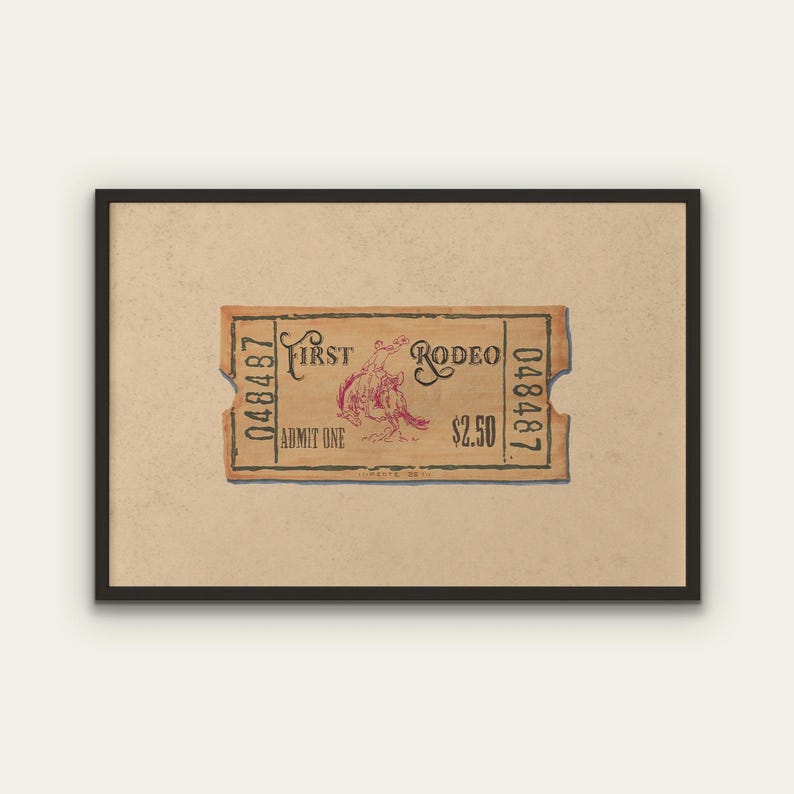 May include: A framed print of a vintage rodeo ticket. The ticket is tan with a red illustration of a rodeo rider and the words "First Rodeo". The ticket also has the text "Admit One" and the price.