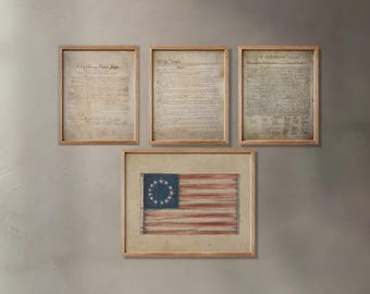 May include: Three framed documents, the Declaration of Independence, the Constitution, and the Bill of Rights, hang on a wall with a framed image of the Betsy Ross flag below them.
