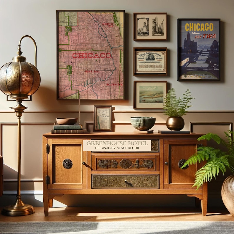 May include: A room featuring a wooden cabinet with decorative drawers and a collection of framed vintage artwork. The artwork includes a Chicago map, cityscapes, and a travel poster. A brass floor lamp and potted plants add to the decor.