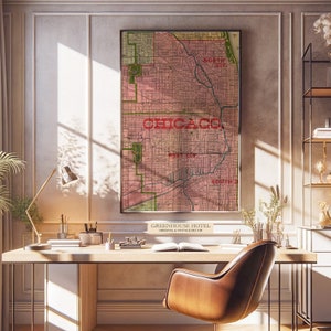 May include: A framed vintage map of Chicago in shades of pink and green, with the city name prominently displayed in red. The map is hanging on a wall above a wooden desk. The text "GREENHOUSE HOTEL ORIGINAL & VINTAGE DECOR" is at the bottom.