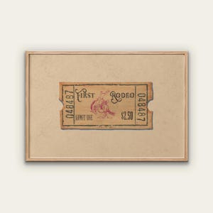 May include: A framed print of a vintage rodeo ticket. The ticket is tan with red text and a graphic of a rodeo rider. The text reads "First Rodeo" and "Admit One". The price is $2.50.