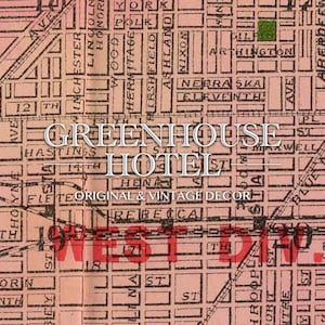 May include: A vintage map print with the words "GREENHOUSE HOTEL" in a decorative font. The map features street names and a grid layout, with the text "ORIGINAL & VINTAGE DECOR" below the hotel name. The map is in shades of pink and brown.