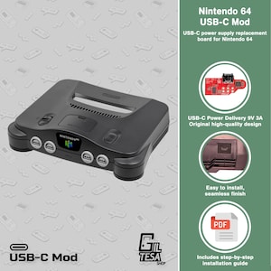 Puede incluir: Una consola de juegos Nintendo 64 negra con una placa de repuesto de fuente de alimentación USB-C. La imagen muestra la consola, una placa de circuito roja, un primer plano del puerto USB-C instalado y un icono PDF. Incluye Nintendo 64 USB-C Mod.