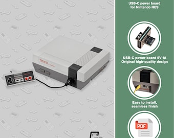 May include: A Nintendo NES console with a USB-C mod, controller, and power board. The console is gray and white with a black stripe. The controller is gray and white with red buttons. The image also includes text that says "USB-C Mod".