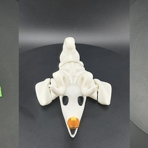 May include: Three articulated figures from The Nightmare Before Christmas. The figures include Oogie Boogie in green, Zero the ghost dog in white, and Jack Skellington in a black and white pinstripe suit.