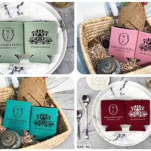 May include: Four sets of personalized can coolers in green, pink, teal, and red. Each cooler features a black and white illustration of a house with the text "Friedheim Inwood" and a monogram with the text "William & Elina" and the date "November 11, 2023".