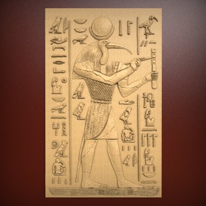 May include: A relief carving of an Egyptian god with a bird head, holding a staff and a symbol. The carving is surrounded by hieroglyphs.