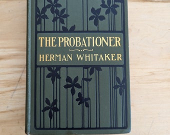 May include: A green book with black floral designs and gold lettering. The title is "The Probationer" by Herman Whitaker.