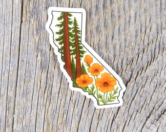 May include: A sticker in the shape of California, featuring illustrations of redwood trees and orange California poppies. The sticker has a white border and is set against a weathered wood background.