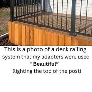 May include: Black deck railing system with vertical bars and a wooden base. The text "Beautiful" is visible in the image. The railing is installed on a wooden deck with a light-colored surface.